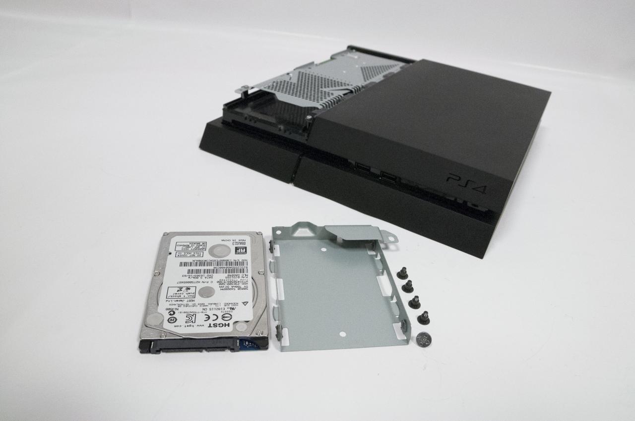 [21/11/2013] PS4 Tipps: Nun müsst ihr nur noch die vier Schrauben am Käfig lösen und könnt eine neue Festplatte einbauen. Danach schraubt ihr alles wieder zusammen und spielt die Recovery-Datei ein.