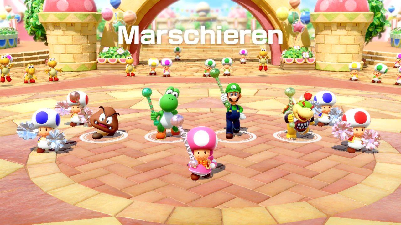 Gumba, Yoshi, Luigi und Bowser Jr. spielen im Modus Beat-Bühne von Super Mario Party für Nintendo Switch das Marschieren-Minispiel.
