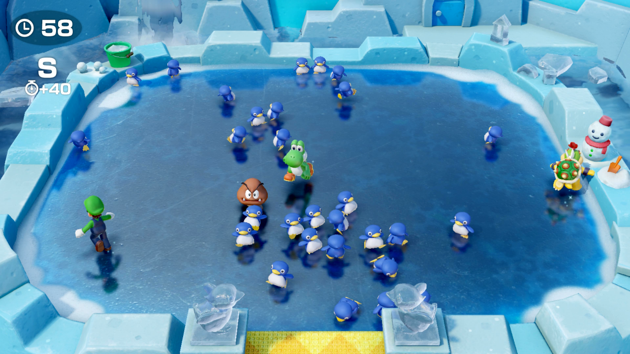Luigi, Yoshi, Gumba und Bowser Jr. fangen in einem Minispiel in Super Mario Party für Nintendo Switch zahlreiche kleine Pinguine ein.