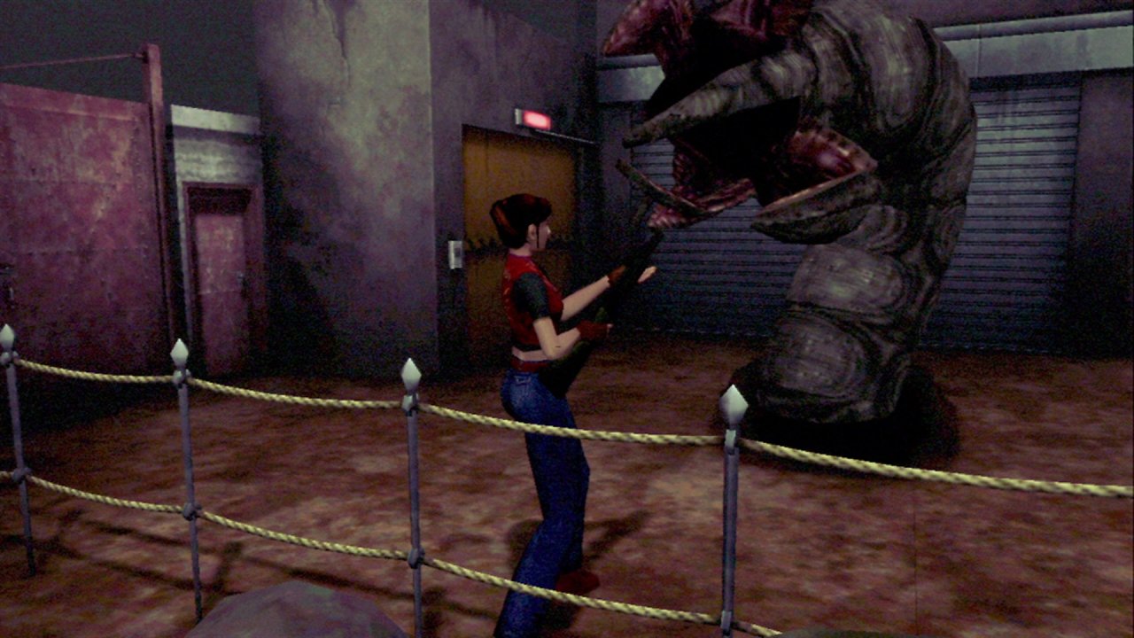 Claire Redfield zielt mit einer Schrotflinte auf einen riesigen Wurm.