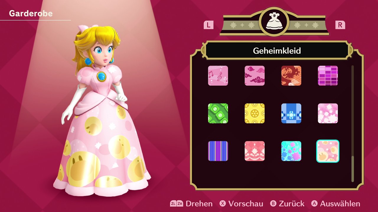 Peach trägt ein Kleid, auf dem die Schüler zu sehen sind, die sie dafür gefunden hat