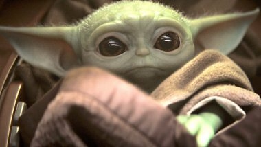 Baby Yoda blickt mit Welpen-Blick in die Kamera.