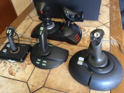 Je größer, desto neuer: Obwohl heutzutage kaum noch Flugsimulationen erscheinen, werden immer noch Joysticks produziert und mit immer mehr Schnickschnack ausgestattet (allen voran der dicke Schubhebel des T.Flight Hotas X von Thrustmaster, der ganz hinten zu sehen ist).